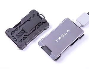 Close-up of minimalist metal AirTag wallet with carbon fiber texture and money clip