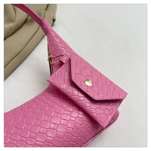 Detailed macro view of pink woven texture handbag and detachable small coin purse pouch