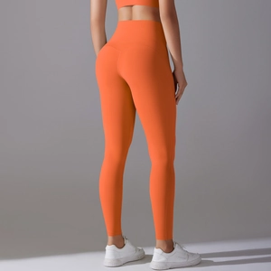 Rear view of high waist seamless yoga leggings in bright orange with matte texture