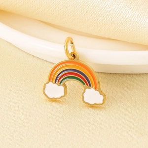 Detailed macro view of a colorful enamel rainbow and white cloud pendant with gold finish