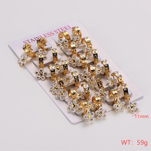 Detail of 12 pairs stainless steel gold hoop earrings with white enamel flower charms