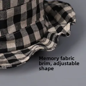 Close-up of linen checkered hat brim with adjustable memory wire for shapeable styling