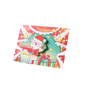 3D pop-up Christmas greeting card with Santa Claus and gift box on white background