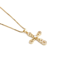 Detail of gold zircon cross pendant featuring interlocking diamond rings on a box chain