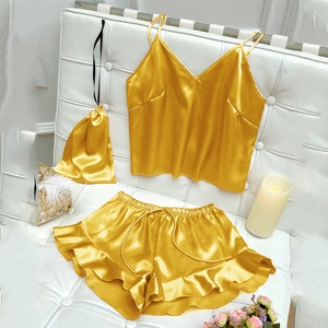 Vue détaillée de l'ensemble pyjama en satin doré avec caraco, short à volants et pochette