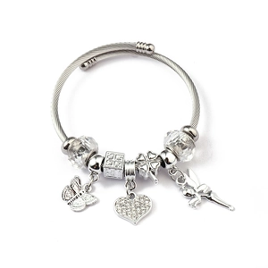 Detailed view of silver cable bangle with butterfly, heart, and fairy charms