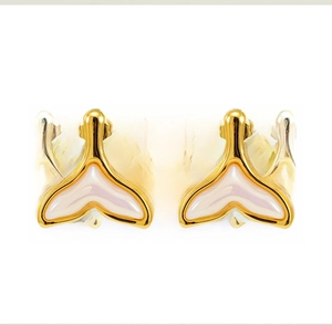 Macro detail of 18K gold-plated fishtail stud earrings with iridescent white resin inlay