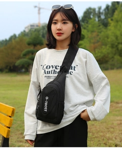 Close-up of black oxford cloth chest bag featuring breathable mesh side pocket and logo