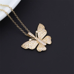 Detailed view of a gold-plated butterfly pendant set with sparkling zircon stones