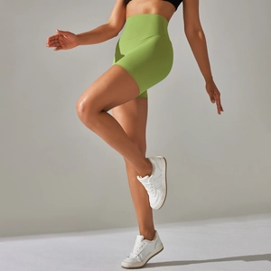 Detail of high-waist avocado green yoga shorts showing breathable and elastic fabric