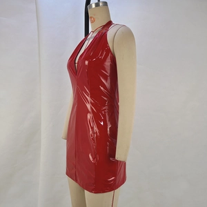 Detail view of glossy red patent leather fabric with deep V-neck and halter neckline