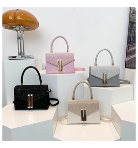 Collection of structured handbags in black, pink, and white with glitter flap details