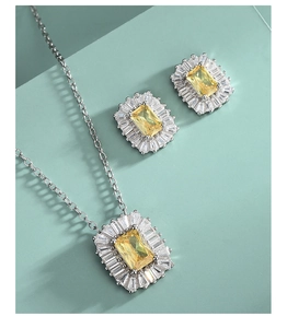 Macro view of rectangular yellow diamond necklace and earrings in silver-tone setting