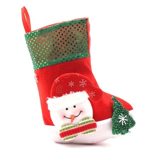 Red Christmas stocking with sequined green cuff and plush snowman decoration