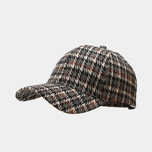 Detailed close-up of brown houndstooth pattern fabric on a classic baseball cap crown