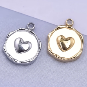 Macro shot of silver and gold heart pendants with hammered edges for jewelry making