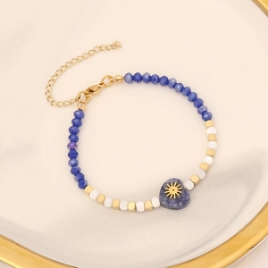 Beaded heart bracelet with blue natural stone pendant and gold solar star charm details