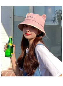Close-up of pink bucket hat featuring cute 3D cat ears and embroidered whisker details