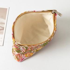 Detail view of large capacity floral makeup bag with metal zipper and canvas lining