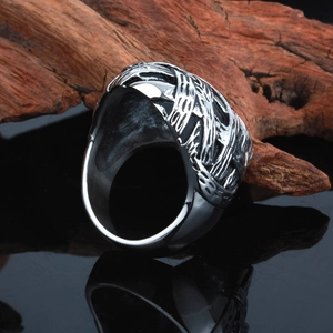 Close-up of vintage gothic stainless steel ring with intricate hollow weave texture