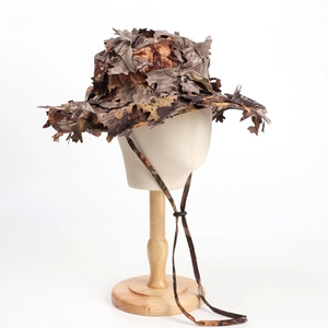 Detail of 3D bionic camouflage leaves on a hunting boonie hat with windproof rope