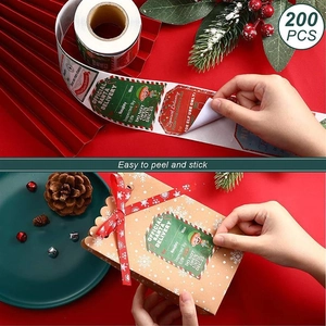Detail showing 200 Christmas stickers roll on a gift box with a festive holiday setting