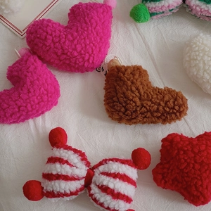 Close-up of assorted plush heart and star ornaments in lamb wool for DIY Christmas decor