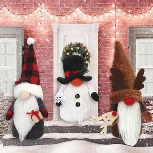 Three Christmas gnomes with pointed hats and plush beards on snowy stairs decor