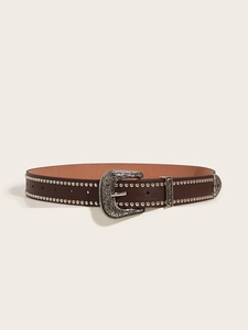 Macro detail of western retro leather belt with silver rivets and carved alloy buckle