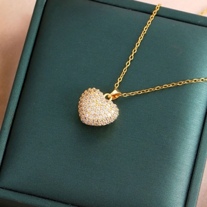 Elegant gold titanium heart necklace featuring shimmering zircon micro-pave pendant