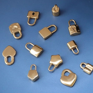 Collection of various 18K gold-plated padlock charms in heart and star shapes on blue background