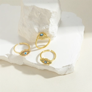 Three-piece gold adjustable evil eye ring set with colorful crystals on white stone base