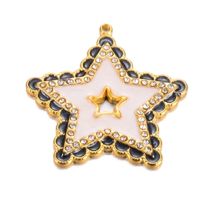 Macro view of a gold star charm featuring black wavy edges and white pearlescent inlay