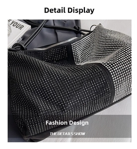 Macro shot of gradient rhinestone pattern and wavy texture on the luxury black tote bag