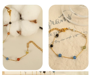 Detail showing the adjustable lobster clasp and colorful beads on the gold chain