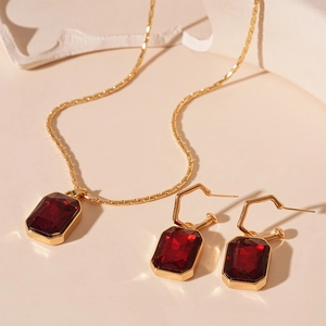 Vintage gold necklace and earrings set with rectangular red crystal gemstones