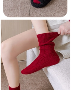 Detail showing the thick rib knit texture and elasticity of red winter thermal socks