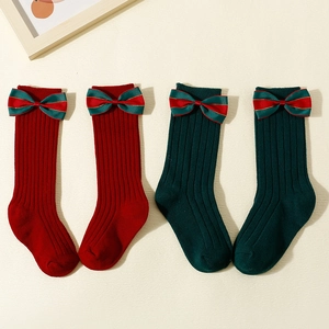 Christmas baby knee high socks in red and green knit with elegant bow details