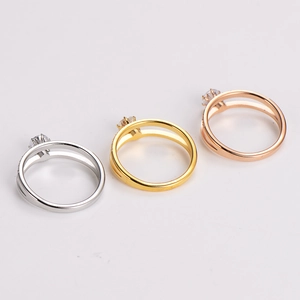 Macro shot of double-layered stainless steel rings with claw-set round zirconia stones