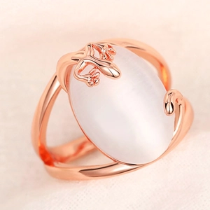 Macro shot of rose gold lizard ring with large oval white translucent gemstone detail
