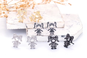 Detail view of cute girl-shaped stud earrings with inlaid cubic zirconia in four finishes