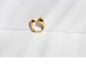 Close-up of minimalist adjustable 18K gold plated brass open ring on a clean white surface