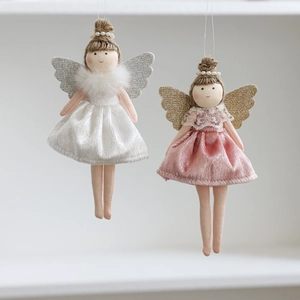Detail of plush Christmas angel dolls with velvet dresses, glitter wings and pearl headbands