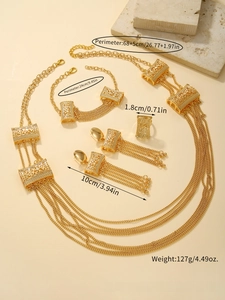 Detail view of 4-piece gold jewelry set with hollow rectangular patterns and long tassels