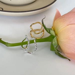 Detail of 925 sterling silver wavy rings on rose stems showing gold and silver finishes