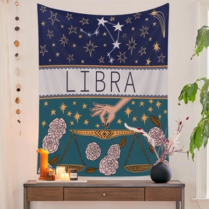 Detail of Libra constellation tapestry with pink roses hanging on a white wall