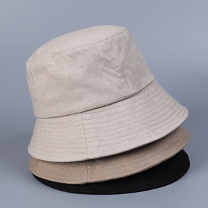 Close-up of linen sun hat textures showing reinforced brim stitching in neutral colors