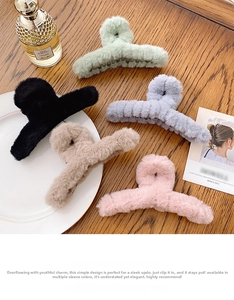Detailed view of large plush hair claws in five colors on a wooden table with props