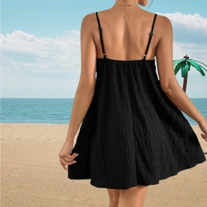 Elegant black backless mini dress with thin straps and crinkled cotton texture