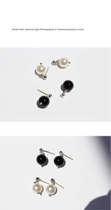 Macro detail shot of white pearl and black onyx stud earrings with silver metal mounts